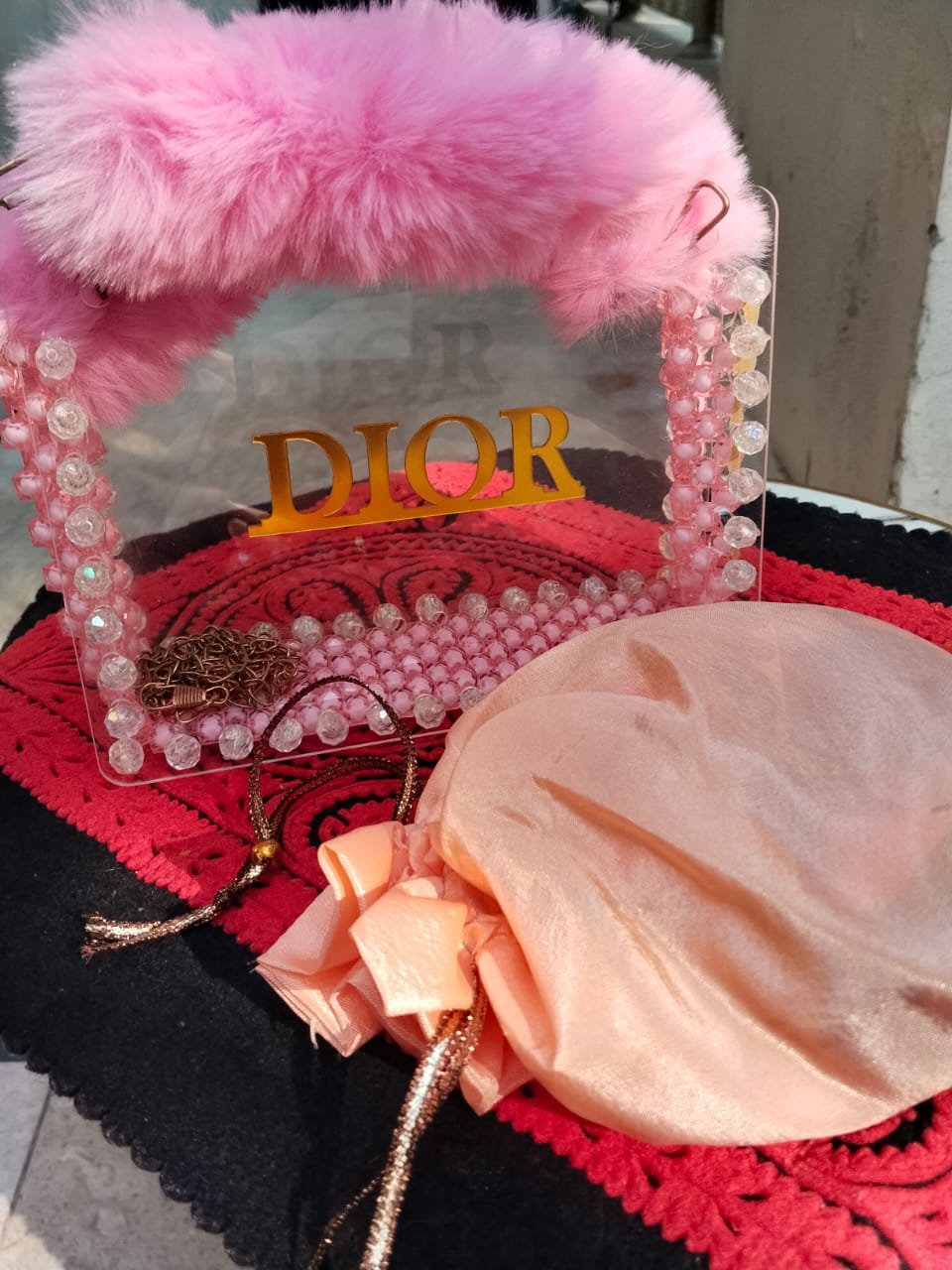 A PINK ARCYLIC HAND BAG